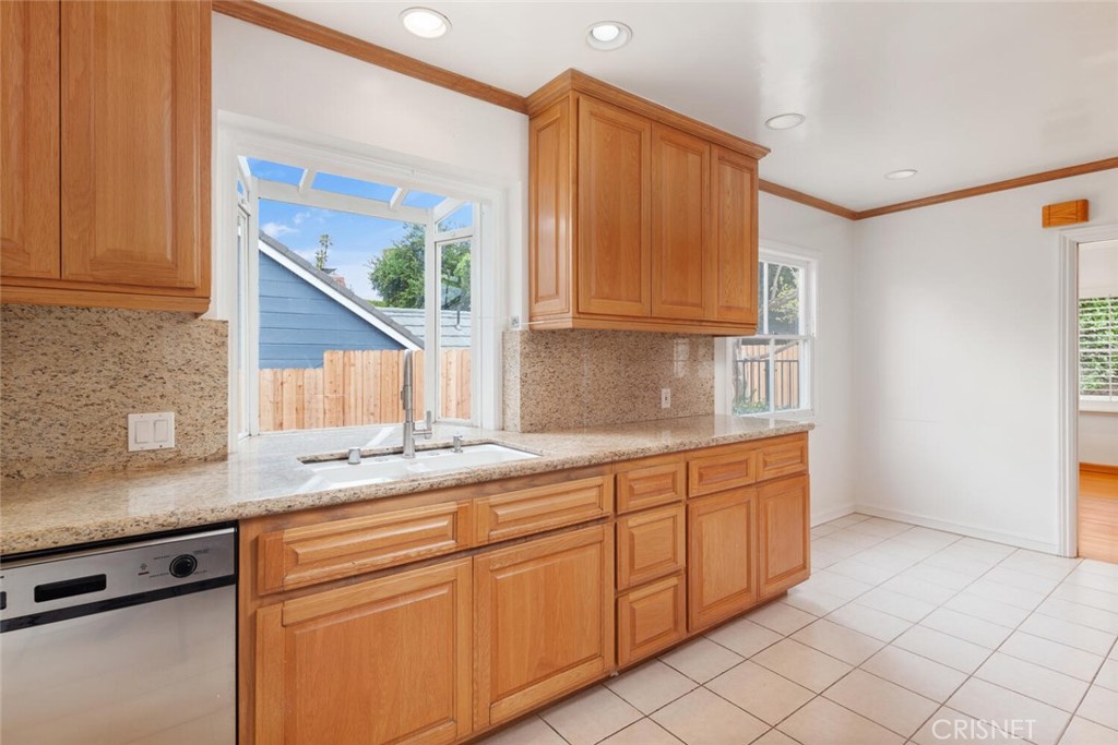 3734 Wrightwood Drive Studio City, CA 91604 - Photo 5 of 28 a kitchen with stainless steel appliances granite countertop a sink and a white cabinets