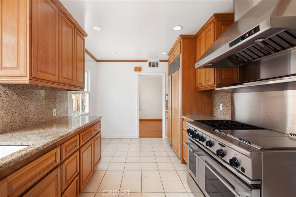 3734 Wrightwood Drive Studio City, CA 91604 - Photo 6 of 28 a kitchen with stainless steel appliances granite countertop a stove and a refrigerator