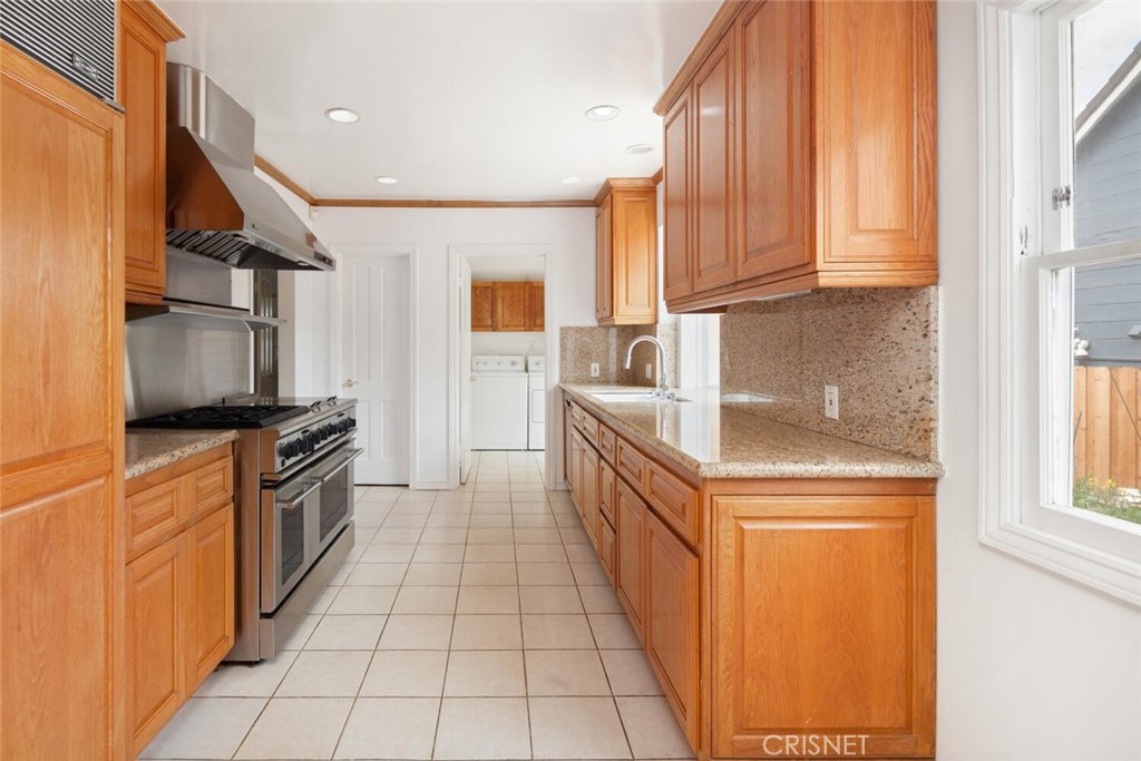 3734 Wrightwood Drive Studio City, CA 91604 - Photo 7 of 28 a kitchen with stainless steel appliances granite countertop a refrigerator and a stove top oven