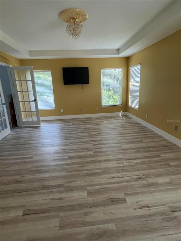 759 Fordingbridge Way Osprey, FL 34229 - Photo 16 of 51 a view of empty room with wooden floor and fan