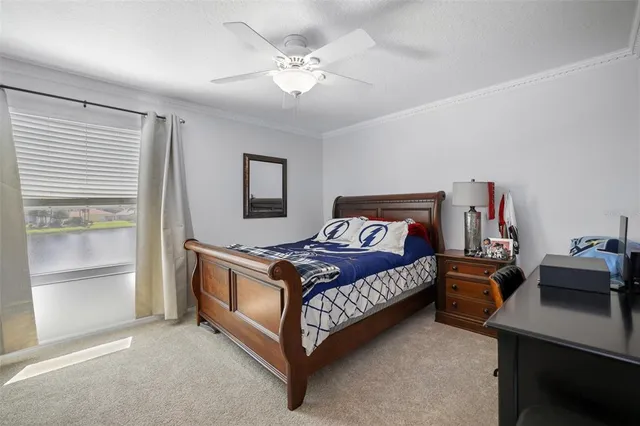 a bed sitting in a bedroom next to a window