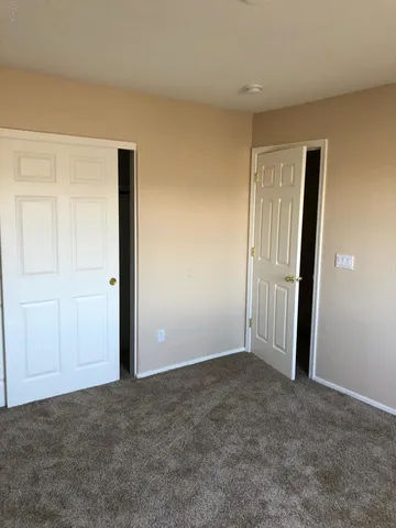 an empty room with closet area