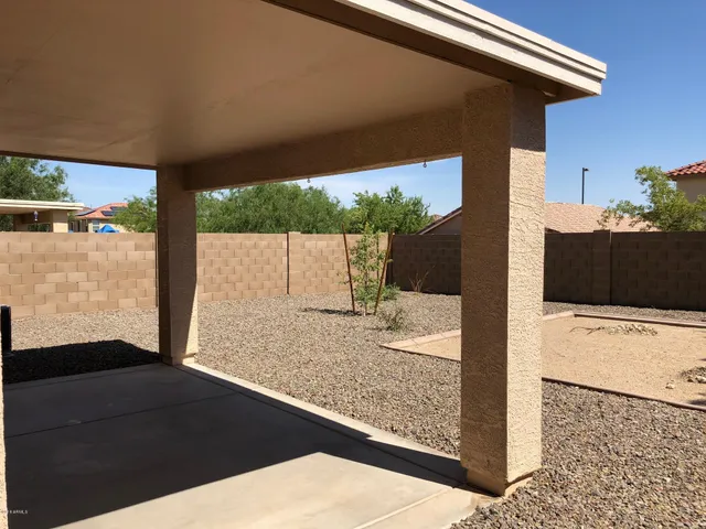 a view of a floor to ceiling window and a wooden deck