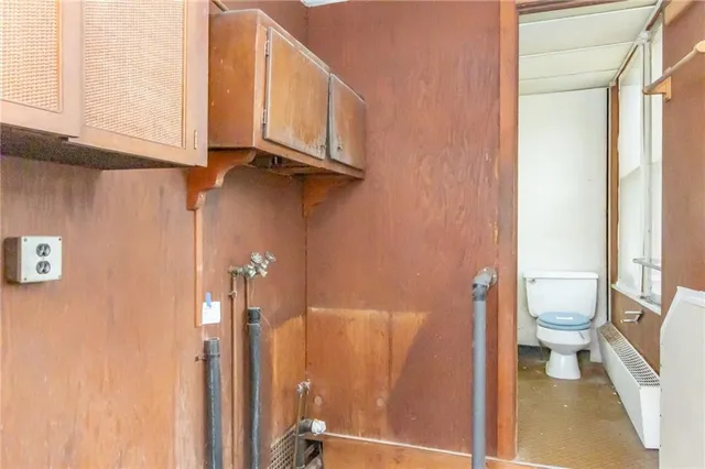 a bathroom with a sink a toilet a mirror and bathtub