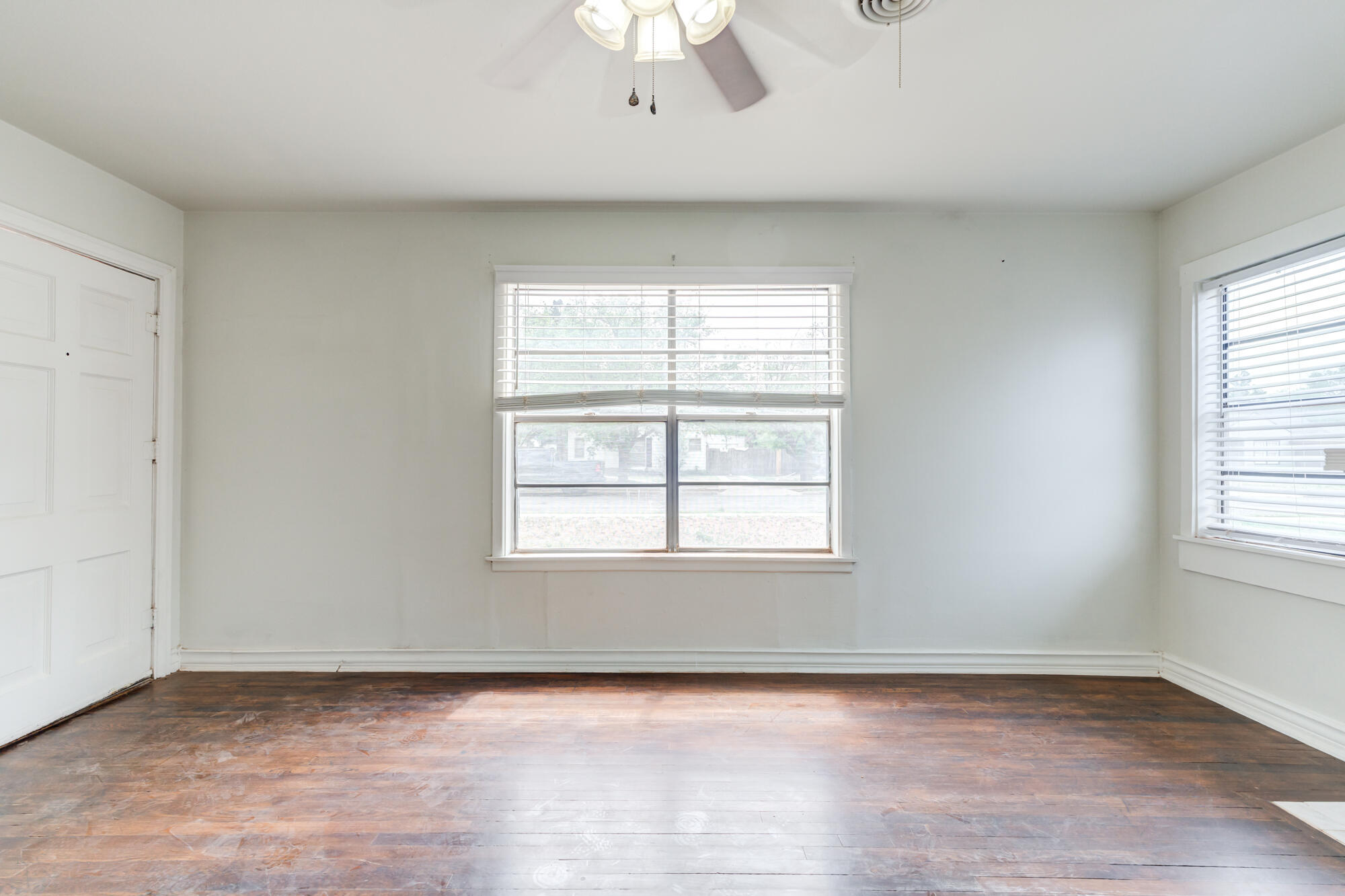 2308 30th Street Lubbock, TX 79411 - Photo 8 of 21 an empty room with wooden floor and windows