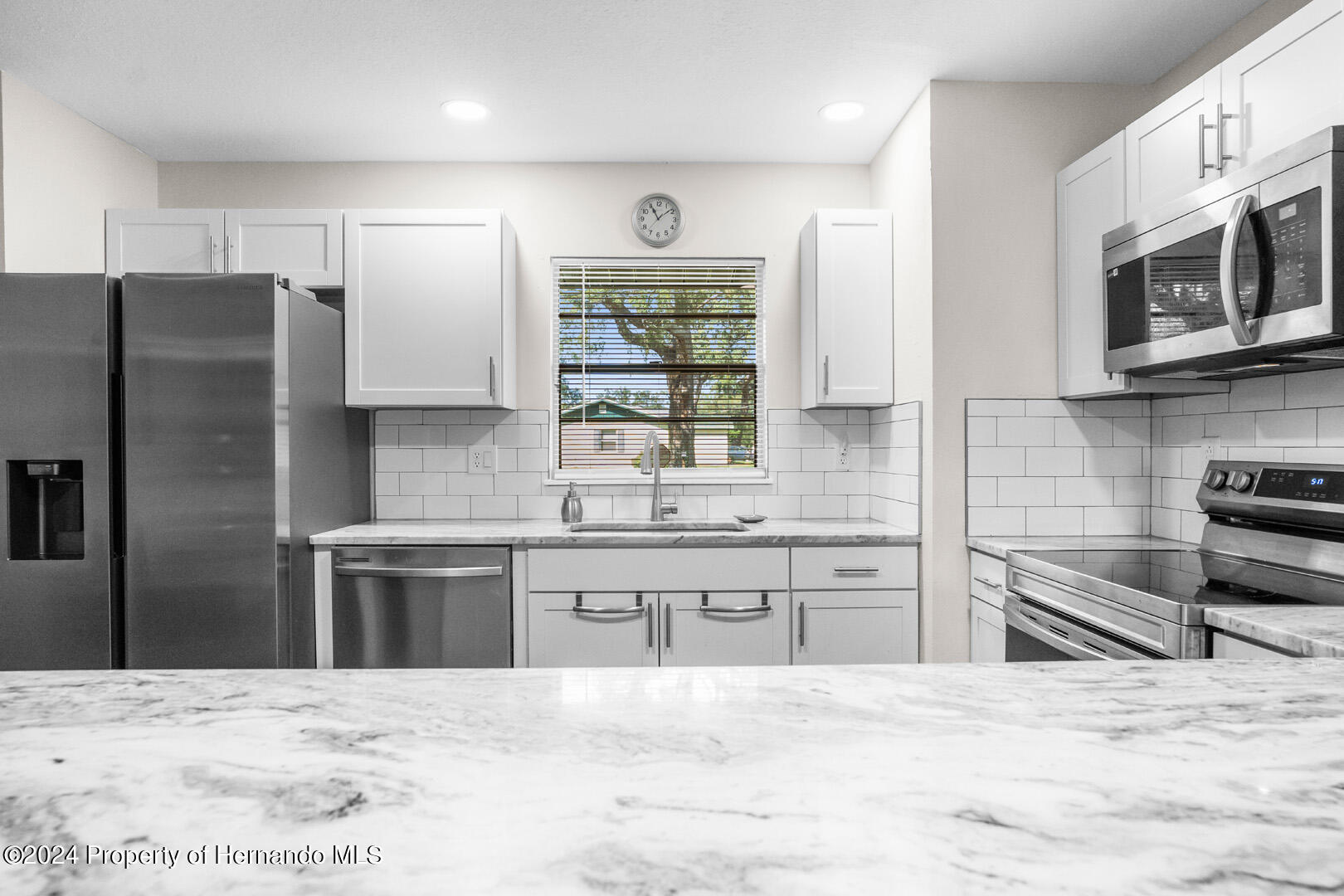 2004 Nobleton Avenue Spring Hill, FL 34608 - Photo 15 of 38 a large kitchen with stainless steel appliances and a refrigerator