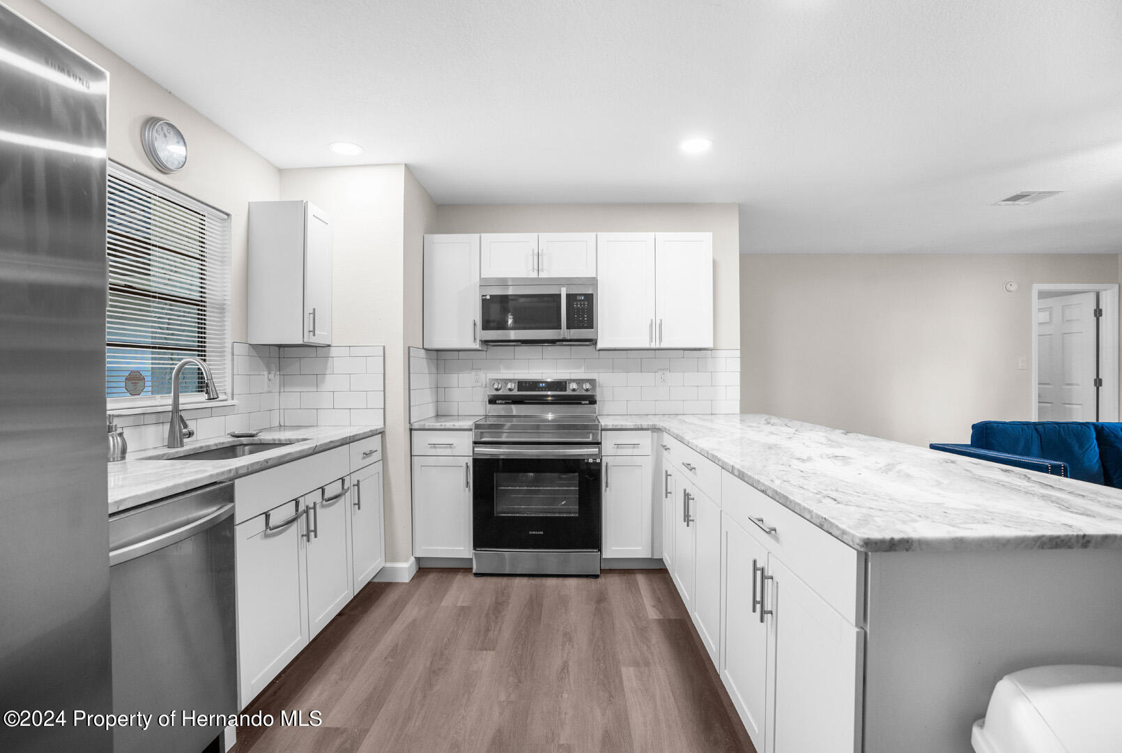 2004 Nobleton Avenue Spring Hill, FL 34608 - Photo 17 of 38 a kitchen with granite countertop a sink stove and refrigerator