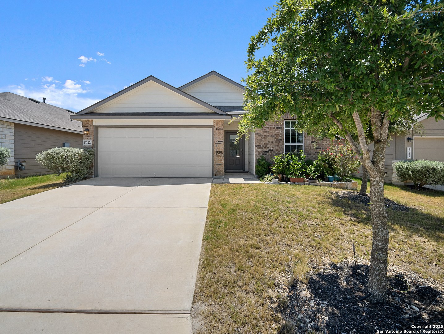 5022 Dancing Gopher San Antonio, TX 78261 - Photo 1 of 36 a front view of a house with a yard and garage