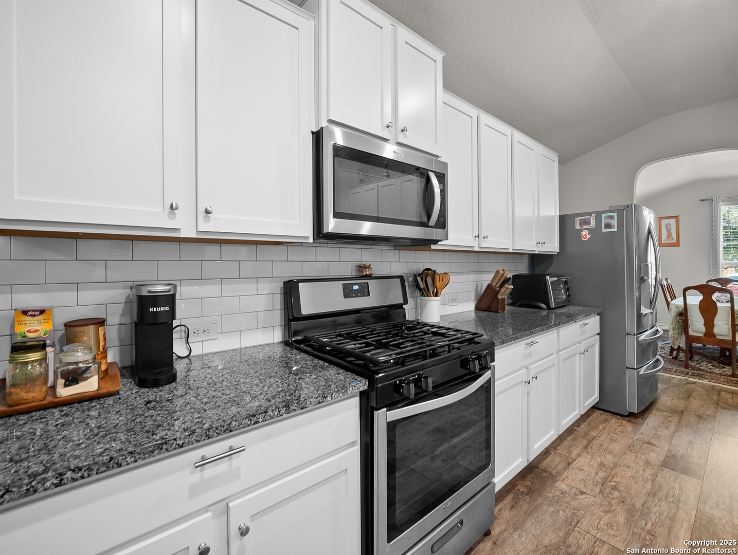 5022 Dancing Gopher San Antonio, TX 78261 - Photo 12 of 36 a kitchen with granite countertop white cabinets stainless steel appliances and a counter space