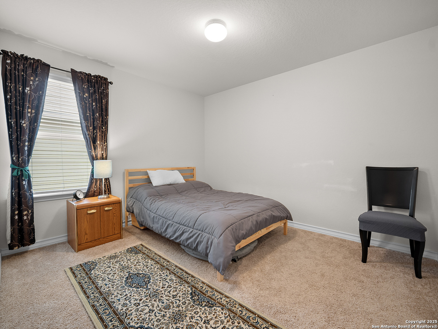 5022 Dancing Gopher San Antonio, TX 78261 - Photo 16 of 36 a bedroom with a bed and chair