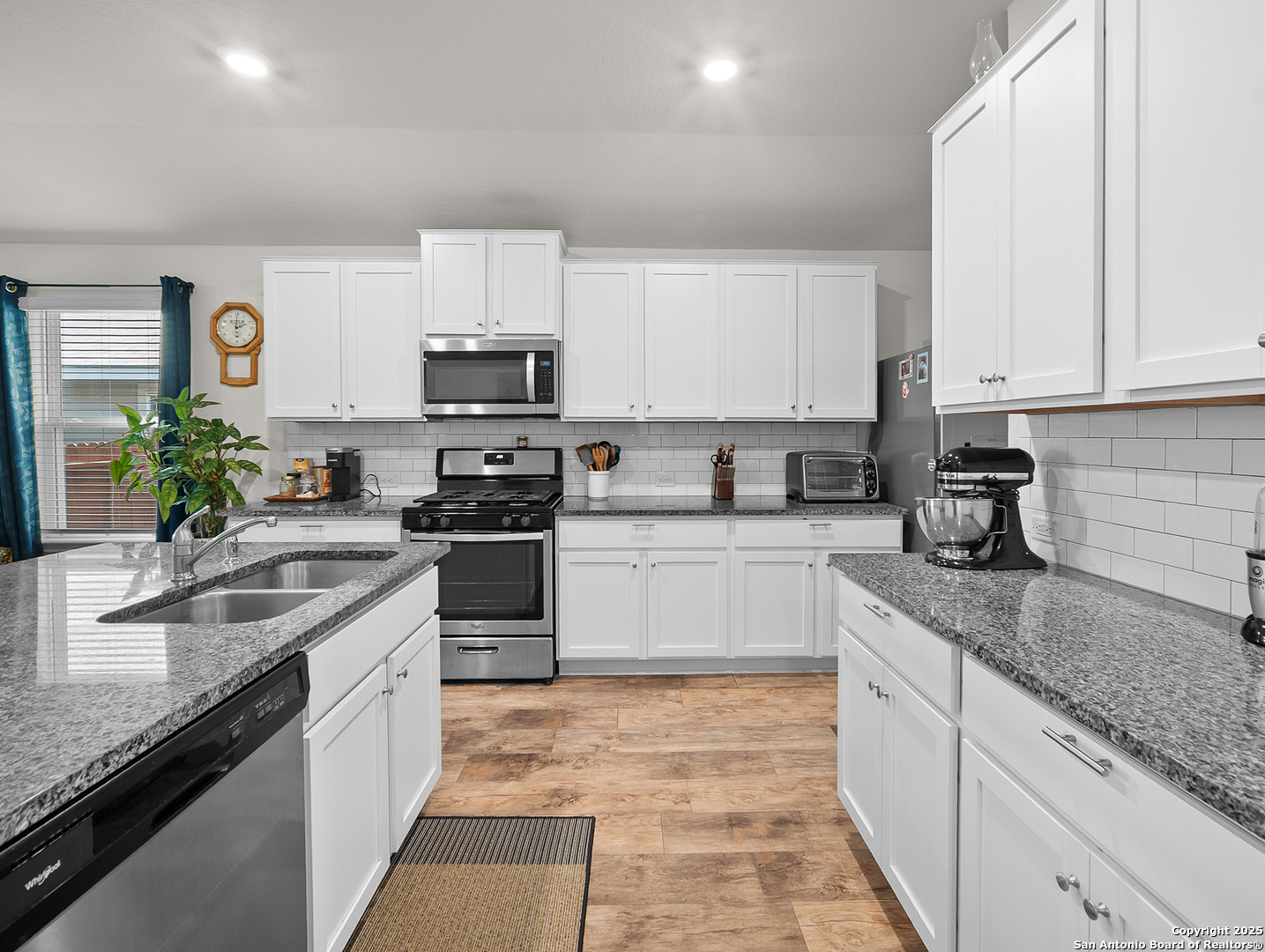 5022 Dancing Gopher San Antonio, TX 78261 - Photo 3 of 36 a kitchen with granite countertop white cabinets and white appliances
