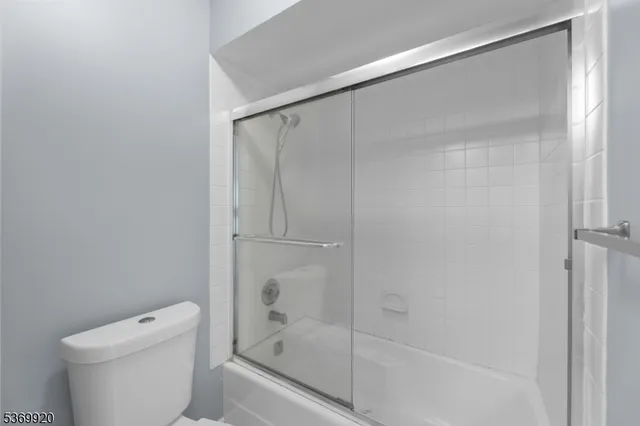 a bathroom with a shower and a toilet