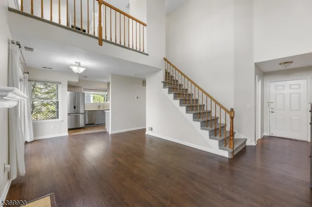 a view of an entryway with wooden floor and stairs