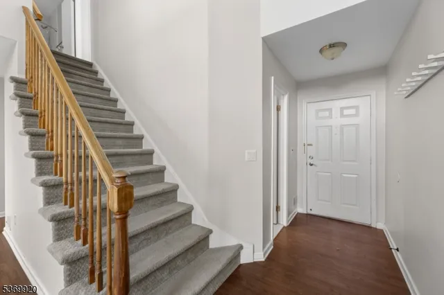 a view of a hallway with wooden floor and entryway