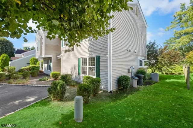a view of a house with a backyard and a garden