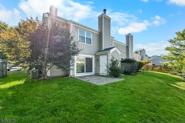 a front view of a house with a garden and plants