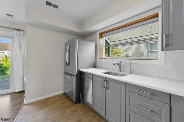 a kitchen with a sink and refrigerator