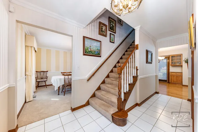 a view of an entryway with workspace and livingroom view