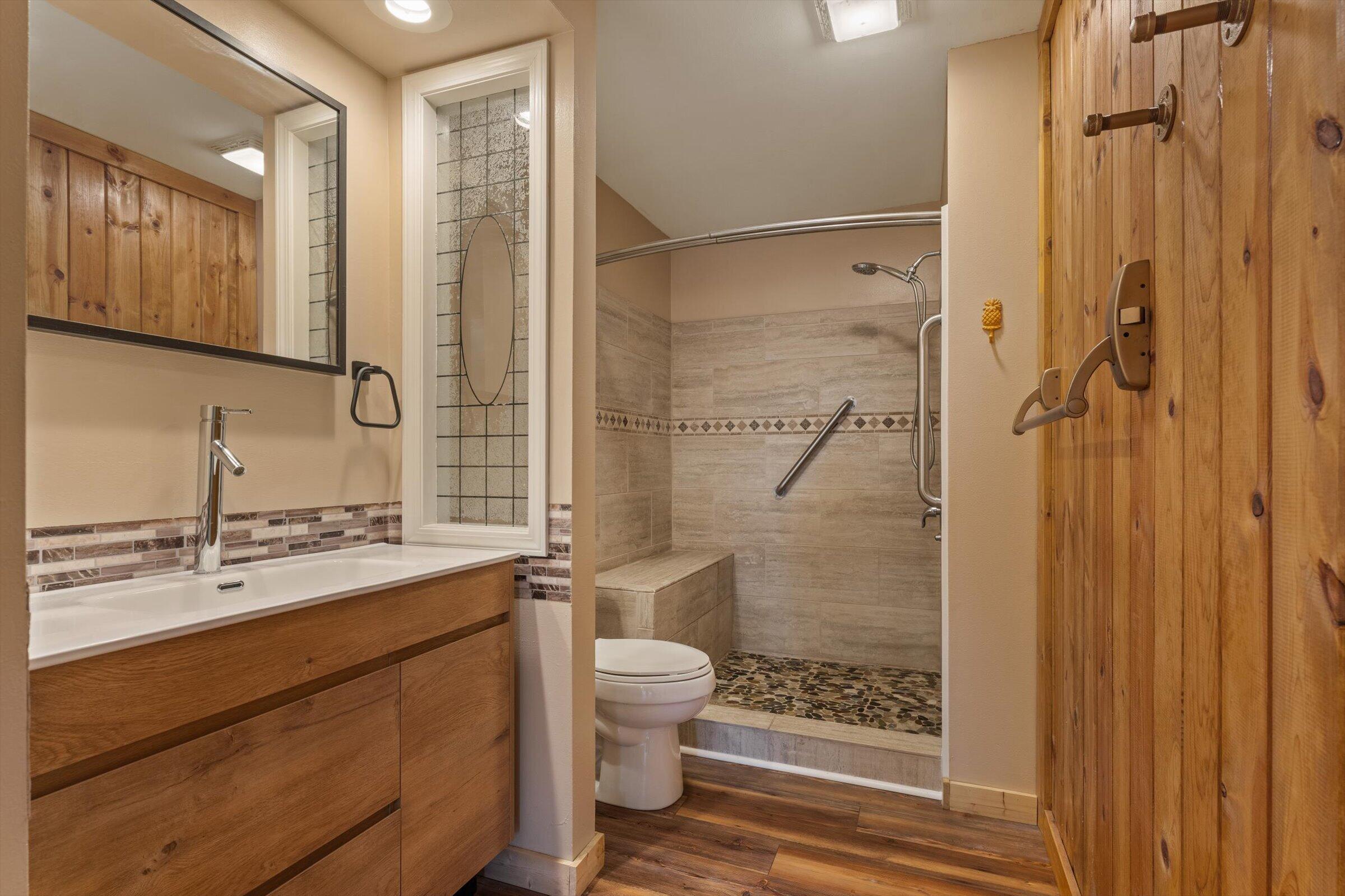 7692 North Emery Road Rolling Prairie, IN 46371 - Photo 23 of 69 a bathroom with a shower sink vanity mirror and toilet