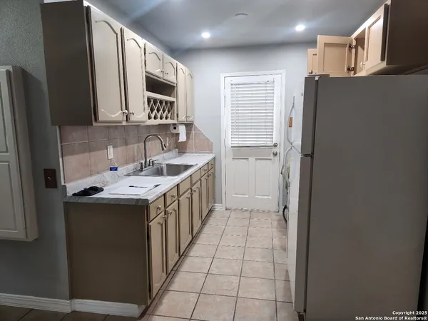 a utility room with cabinets washer and dryer