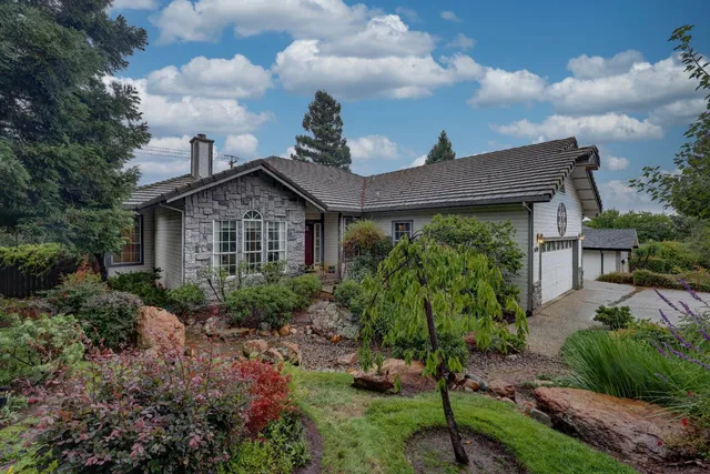 a front view of a house with garden