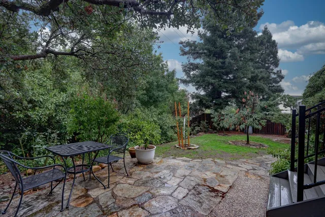 a view of a backyard with sitting area
