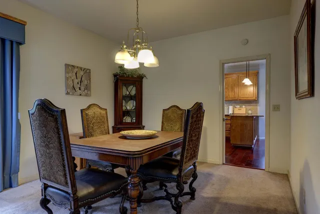 a view of a dining room with furniture and chandelier