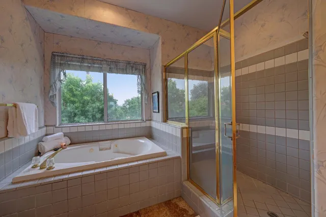 a bathroom with a tub and shower