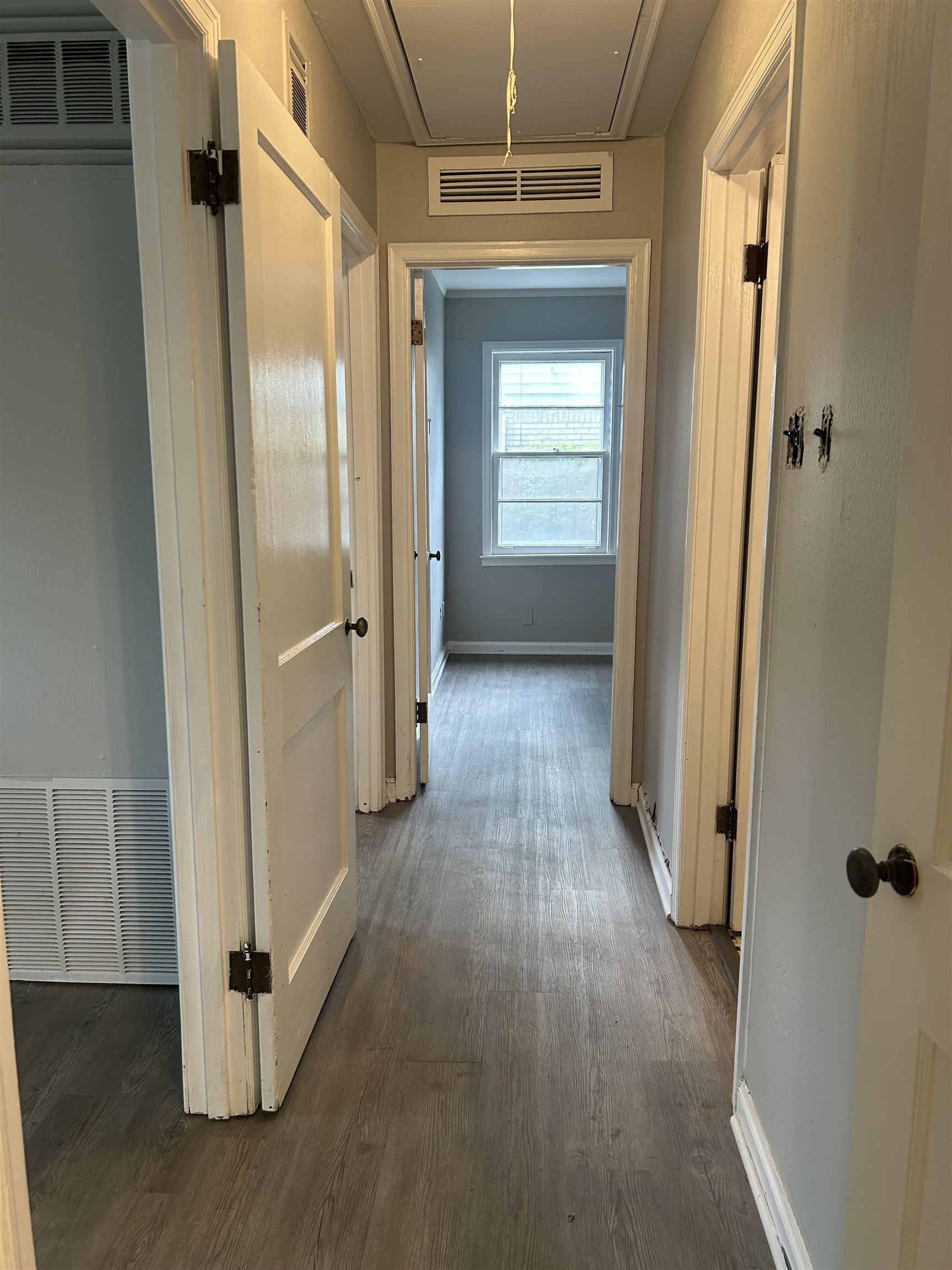4631 Sea Isle Road Memphis, TN 38117 - Photo 13 of 28 Corridor featuring attic access, dark wood-style flooring, and baseboards