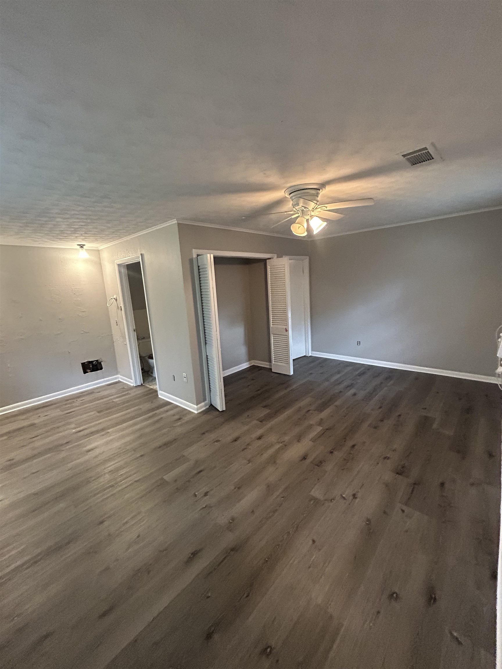 4631 Sea Isle Road Memphis, TN 38117 - Photo 14 of 28 Empty room featuring dark wood-style floors, baseboards, and a ceiling fan