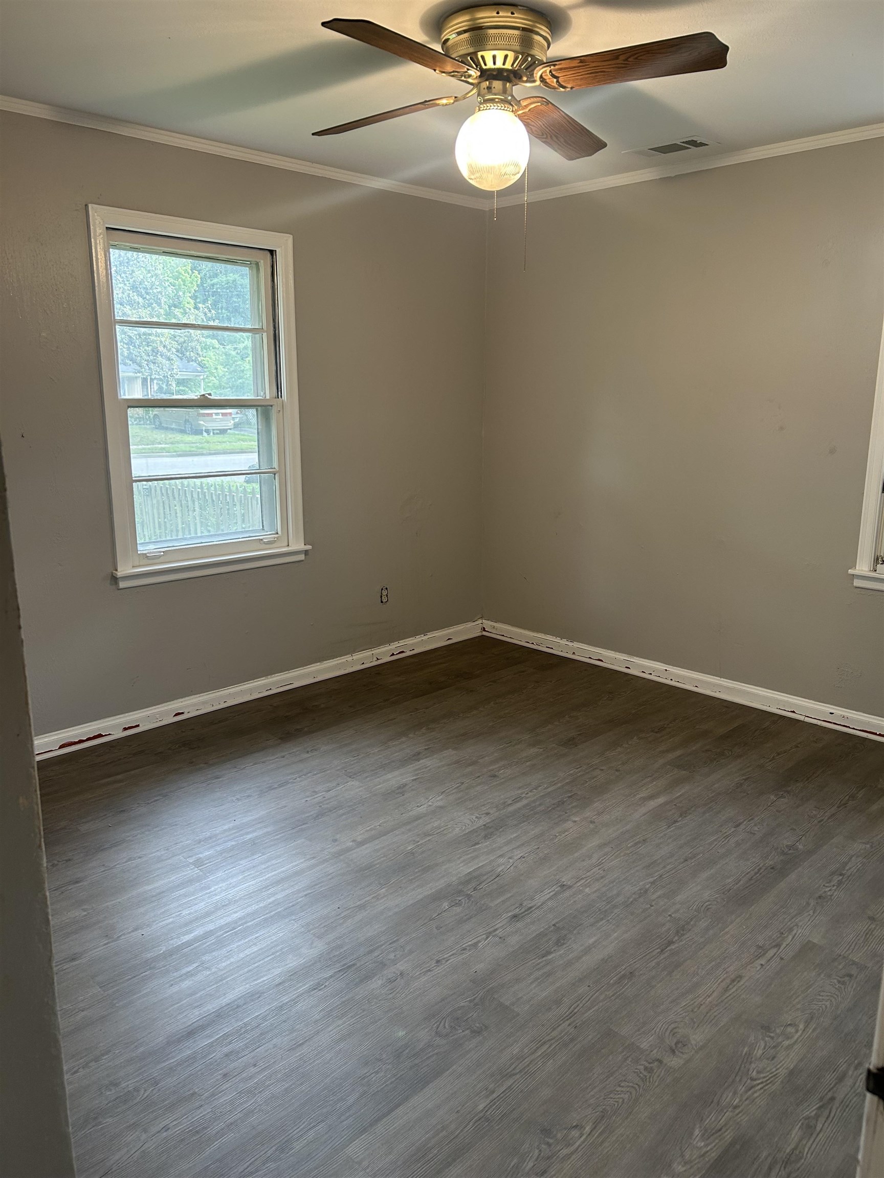 4631 Sea Isle Road Memphis, TN 38117 - Photo 20 of 28 Empty room with ornamental molding, dark wood-style flooring, ceiling fan, and baseboards