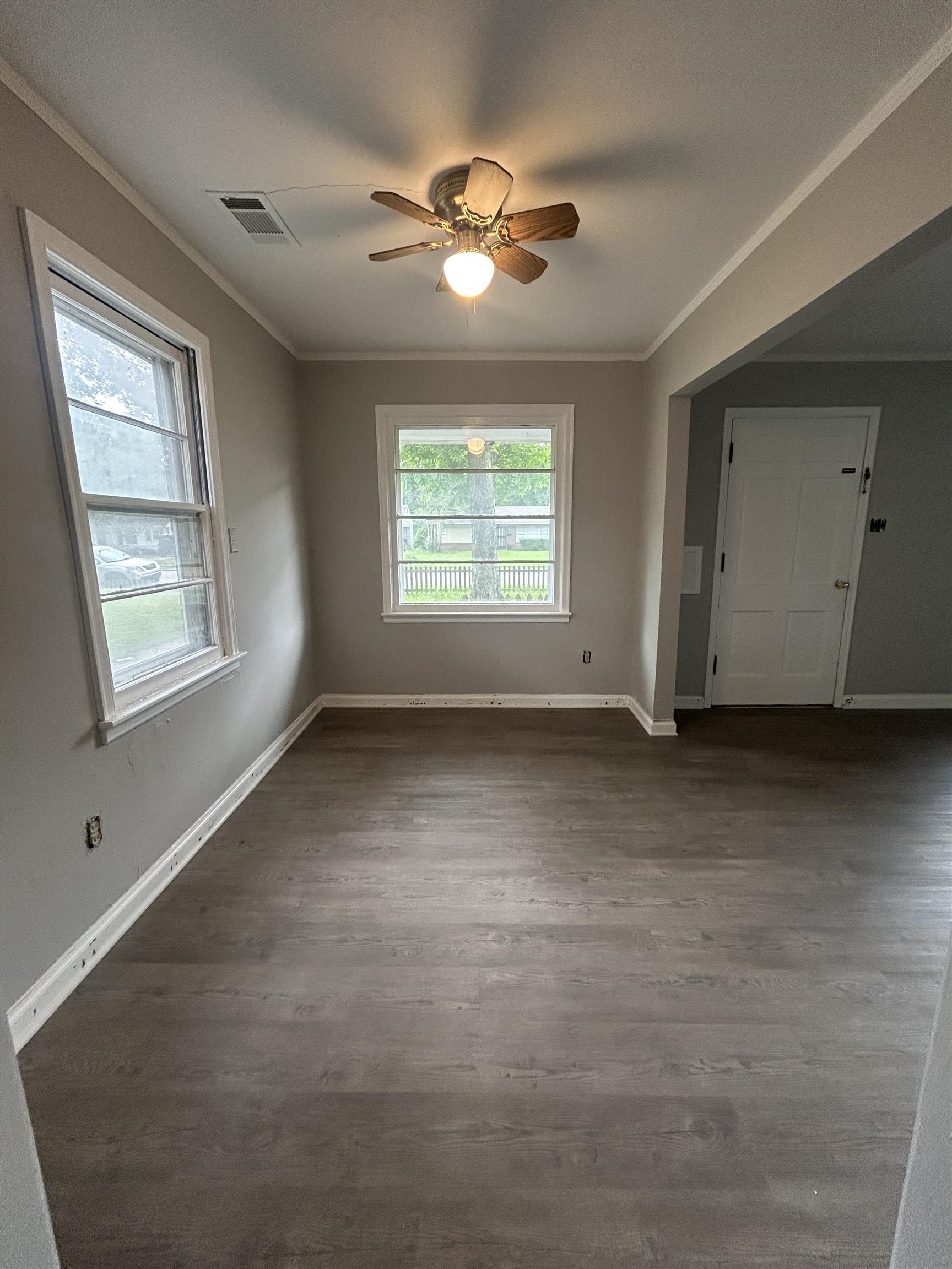 4631 Sea Isle Road Memphis, TN 38117 - Photo 6 of 28 Unfurnished room with ornamental molding, a ceiling fan, dark wood-type flooring, and baseboards