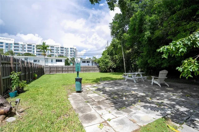 a view of a park with swings and a bench