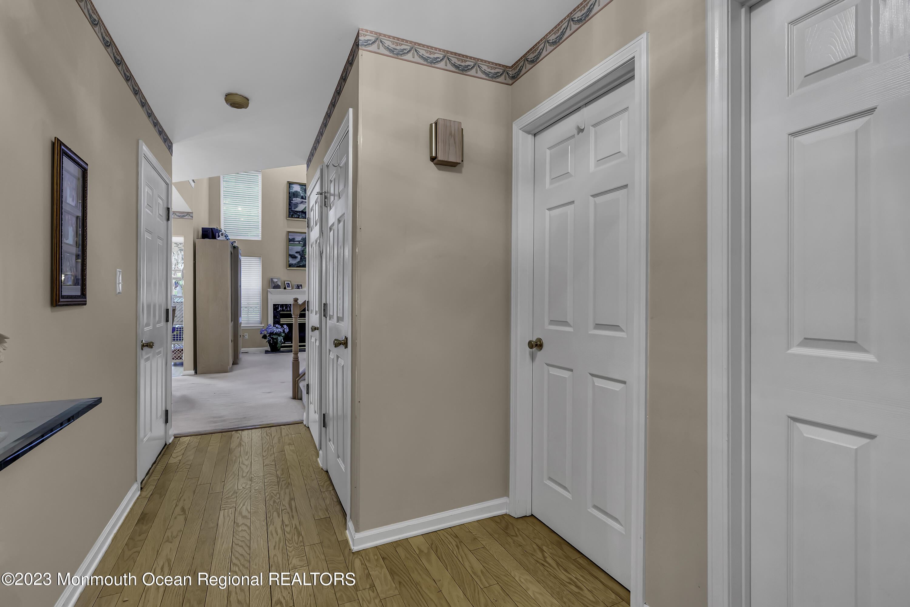 8 Alpine Road, Unit 197 Holmdel, NJ 07733 - Photo 2 of 18 a view of a hallway with wooden floor and closet area