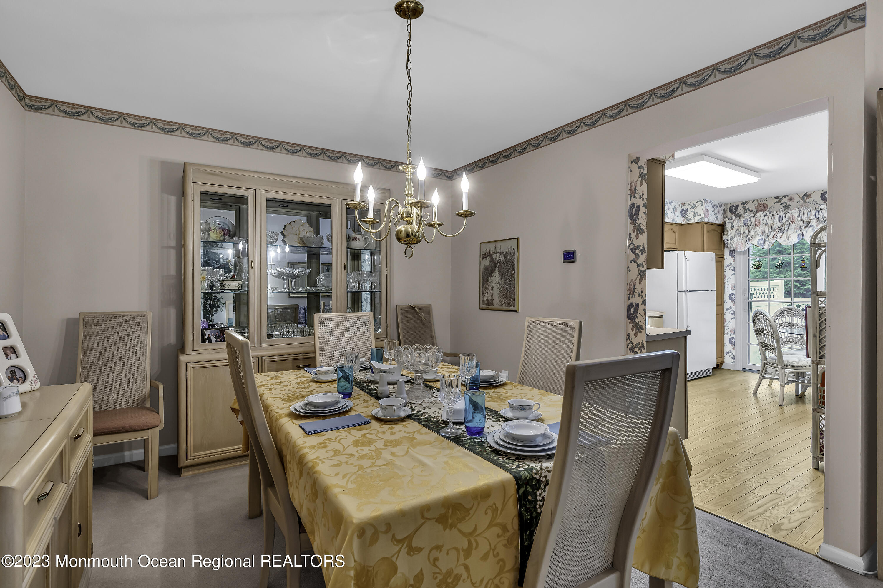 8 Alpine Road, Unit 197 Holmdel, NJ 07733 - Photo 3 of 18 a dining room with furniture a chandelier and wooden floor