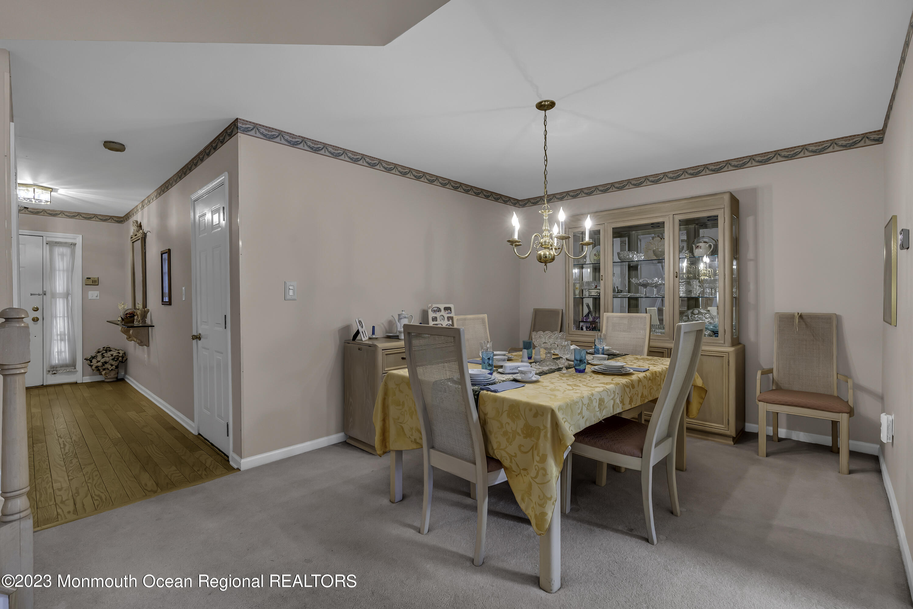 8 Alpine Road, Unit 197 Holmdel, NJ 07733 - Photo 4 of 18 a view of a dining room with furniture and chandelier