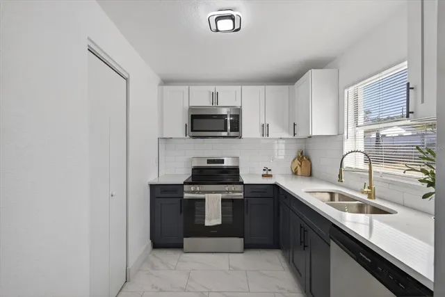 a kitchen with a sink stove and microwave