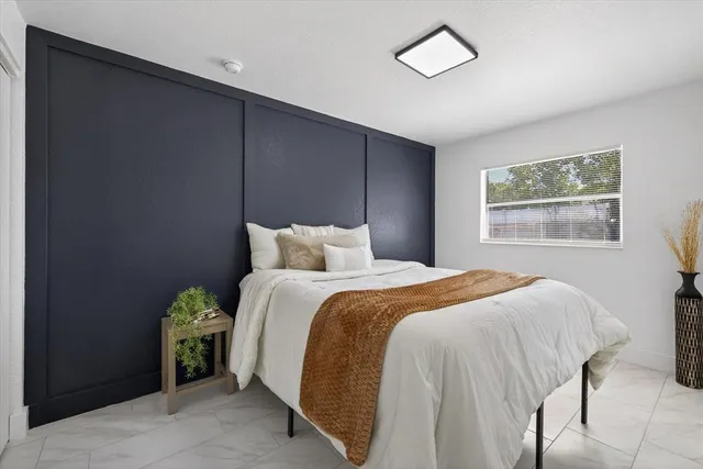 a bedroom with a bed and a window