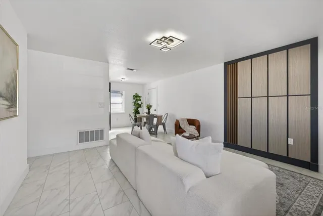 a living room with furniture and a chandelier