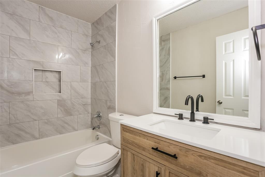 1019 Chelsea Lane Forney, TX 75126 - Photo 13 of 16 a bathroom with a sink a toilet and shower
