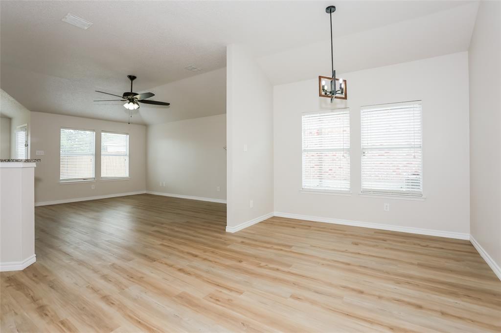 1019 Chelsea Lane Forney, TX 75126 - Photo 4 of 16 a view of an empty room with a window and wooden floor