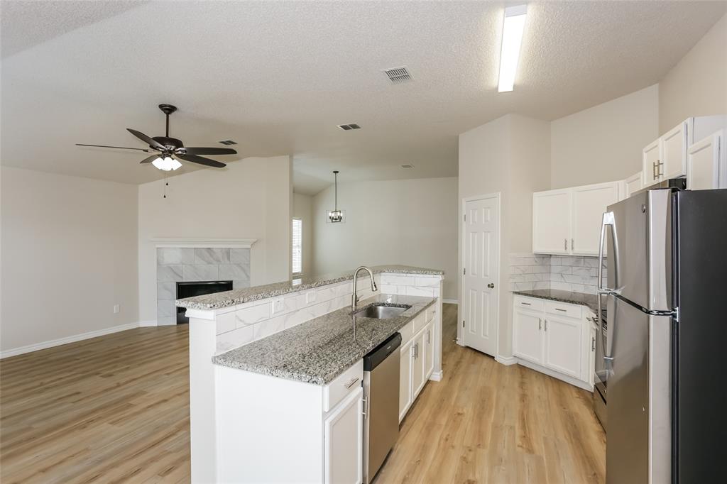 1019 Chelsea Lane Forney, TX 75126 - Photo 6 of 16 a kitchen with a sink appliances and cabinets