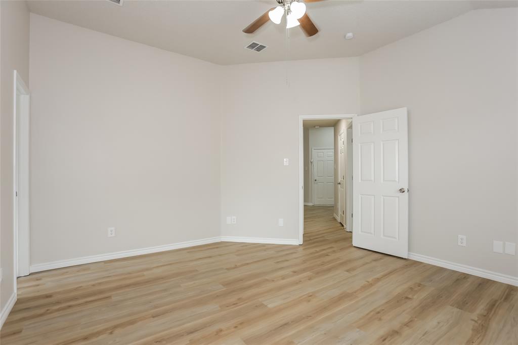1019 Chelsea Lane Forney, TX 75126 - Photo 8 of 16 a view of an empty room with wooden floor