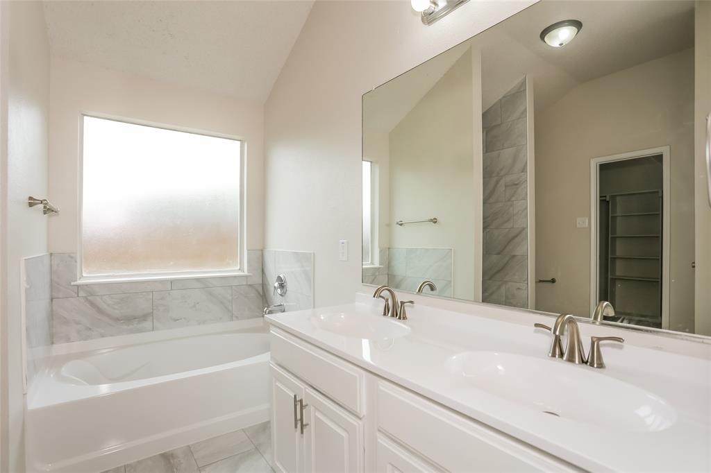 1019 Chelsea Lane Forney, TX 75126 - Photo 9 of 16 a bathroom with a tub sink and mirror
