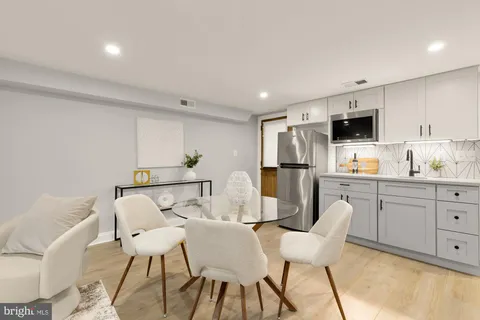 a kitchen with stainless steel appliances kitchen island granite countertop a sink and cabinets