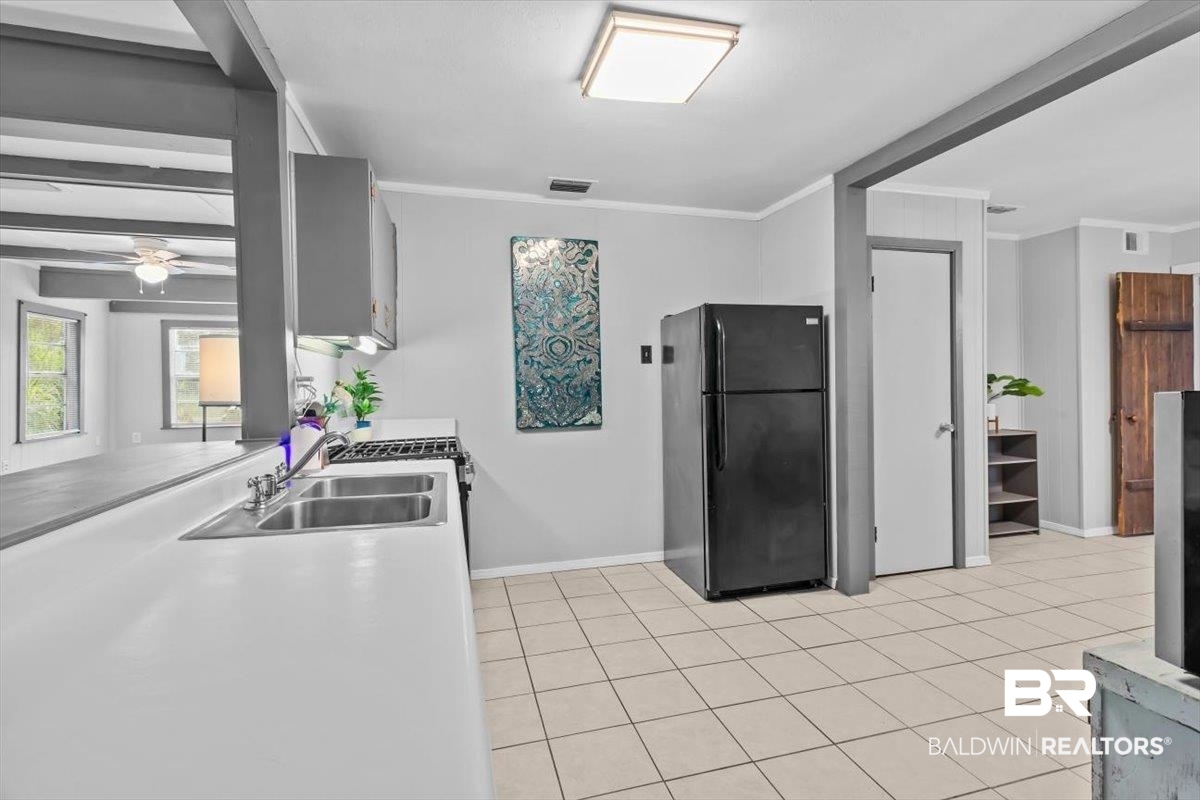 4918 Quimby Drive Mobile, AL 36619 - Photo 9 of 38 Kitchen featuring freestanding refrigerator, a sink, baseboards, a ceiling fan, and light tile patterned floors