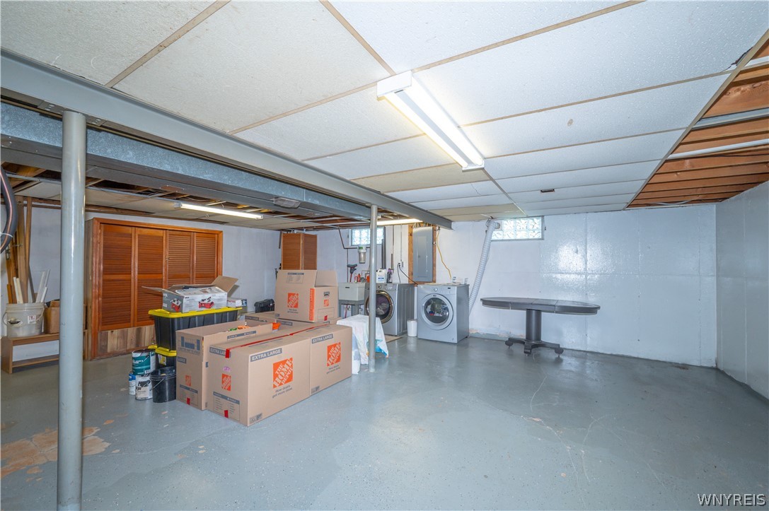 6463 Ward Road Sanborn, NY 14132 - Photo 36 of 49 A spacious unfinished basement provides versatile utility areas alongside the dedicated laundry zone.
