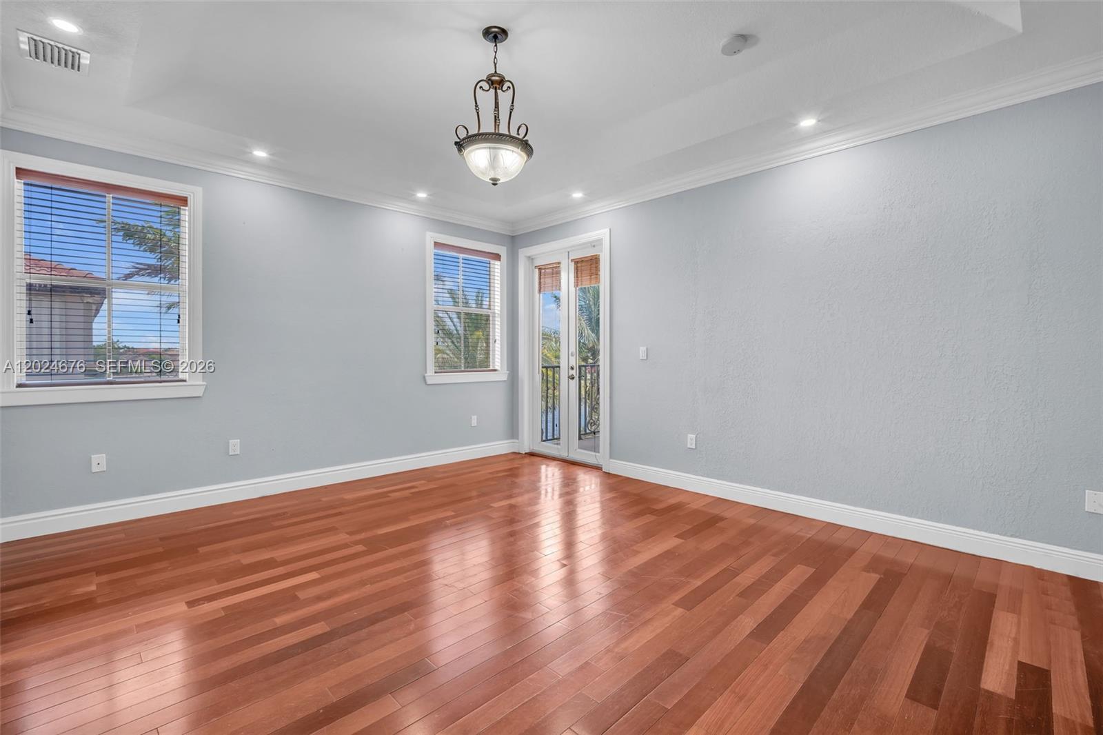 2155 Southwest 156th Court Miami, FL 33185 - Photo 40 of 57 a view of an empty room with wooden floor and a window