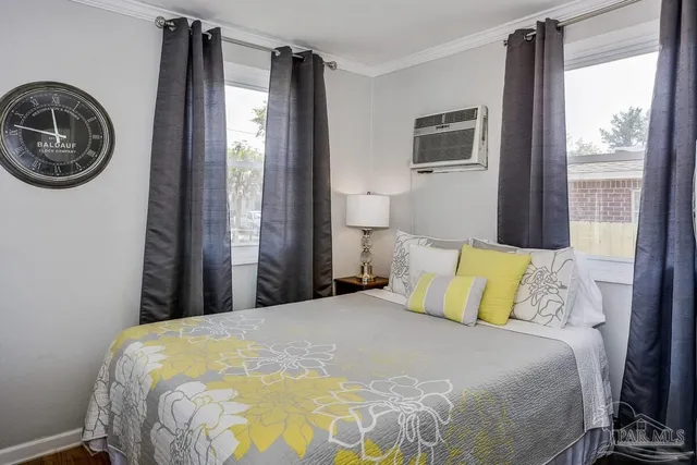 a bedroom with a bed and a window