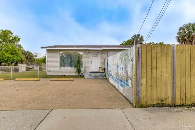 a view of a house with a backyard and a patio